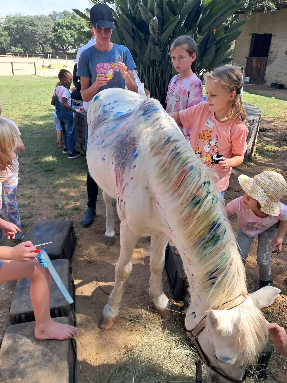 Children painting a pony at a Sun Valley Stables pony party experience